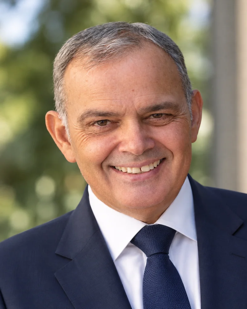 Ο Φώτης Πλακογιάννης σε εξωτερικό χώρο, χαμογελαστός